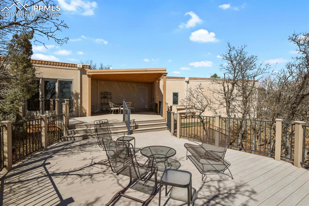 Image 45 of 50: View looking to the home from the huge Trex Deck with Wrought Iron railings