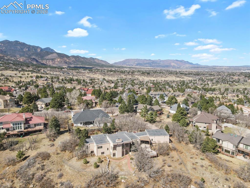 Image 46 of 50: Aerial perspective of suburban area with a mountain backdrop