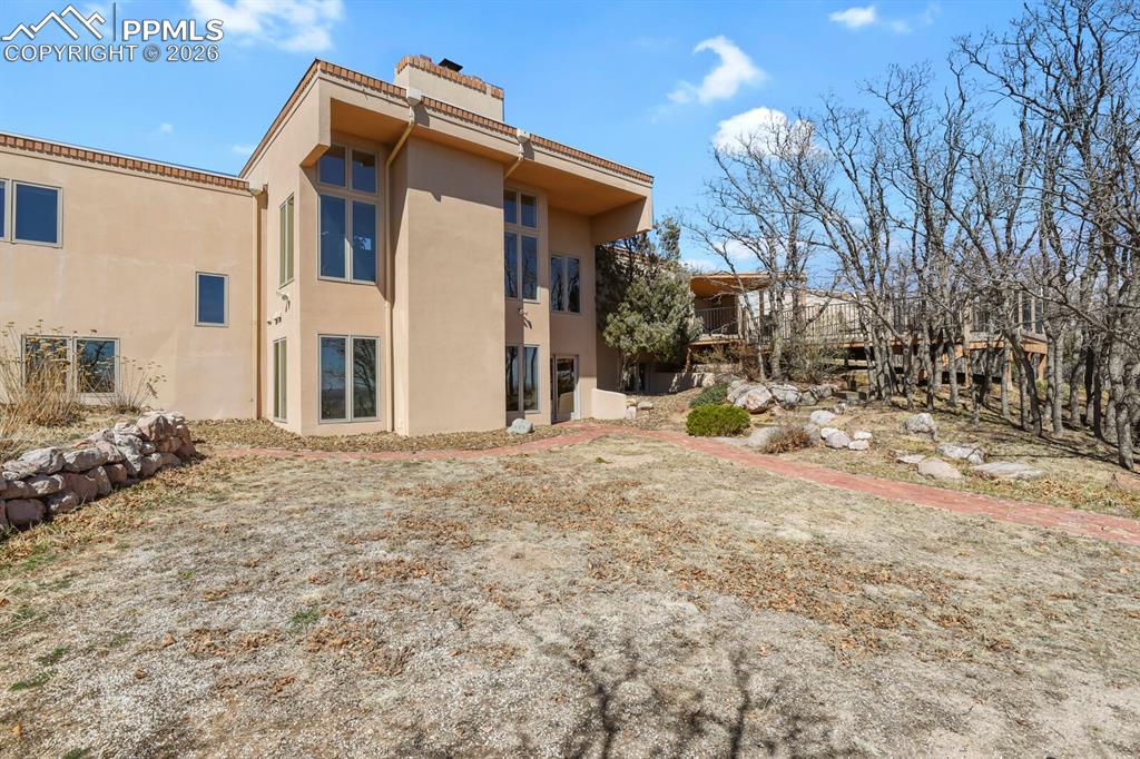 Image 48 of 50: Rear view of stucco finishes on the home.