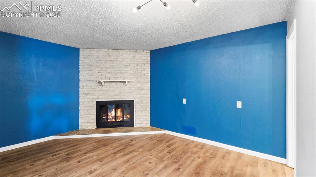 Image 10 of 37: Separate area with fireplace - use as a den, office, or dining room!