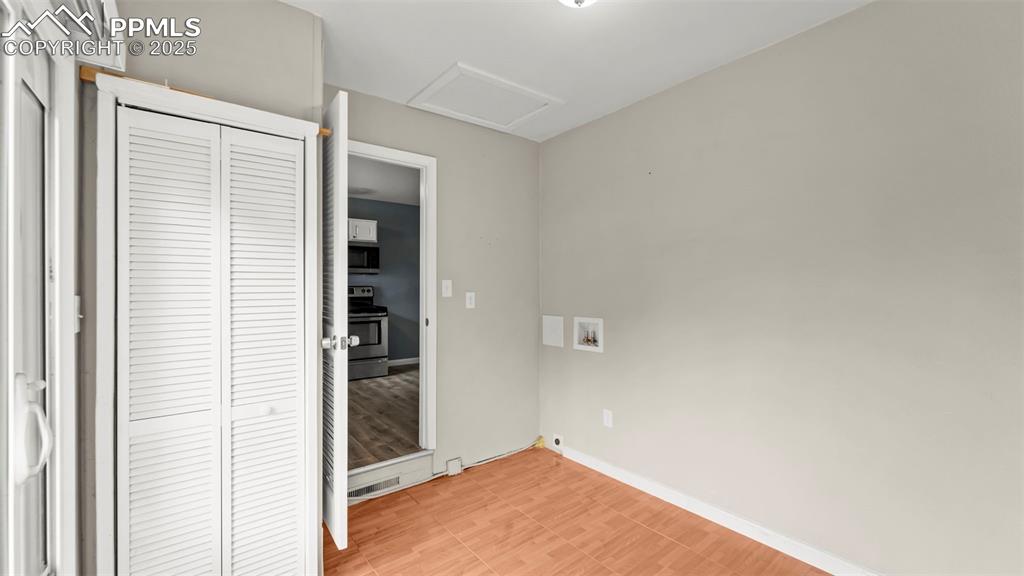 Image 24 of 37: Step down into the laundry room from the kitchen