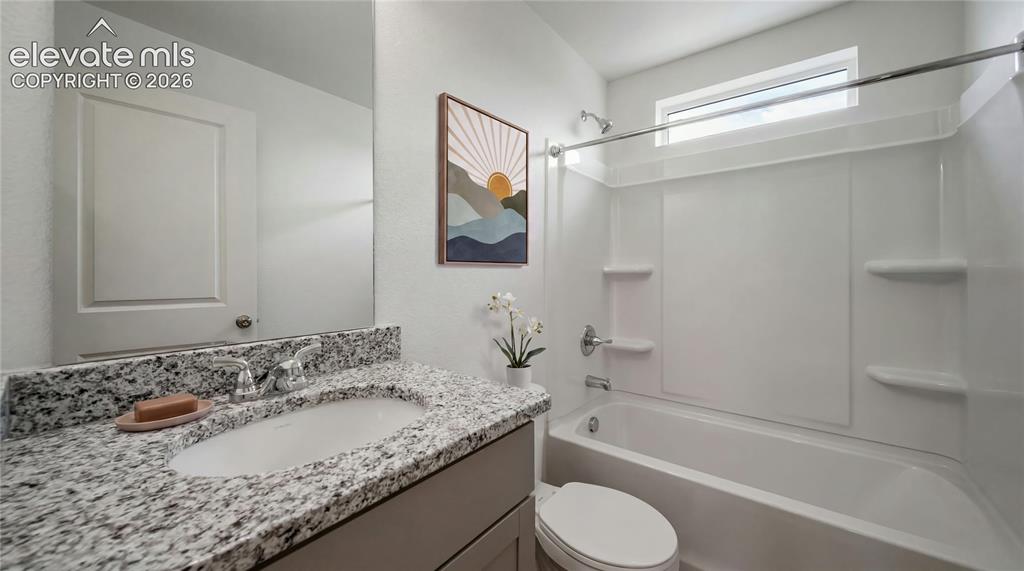 Image 2 of 36: Full bathroom featuring a white drop-in bathtub with integrated shower, a w