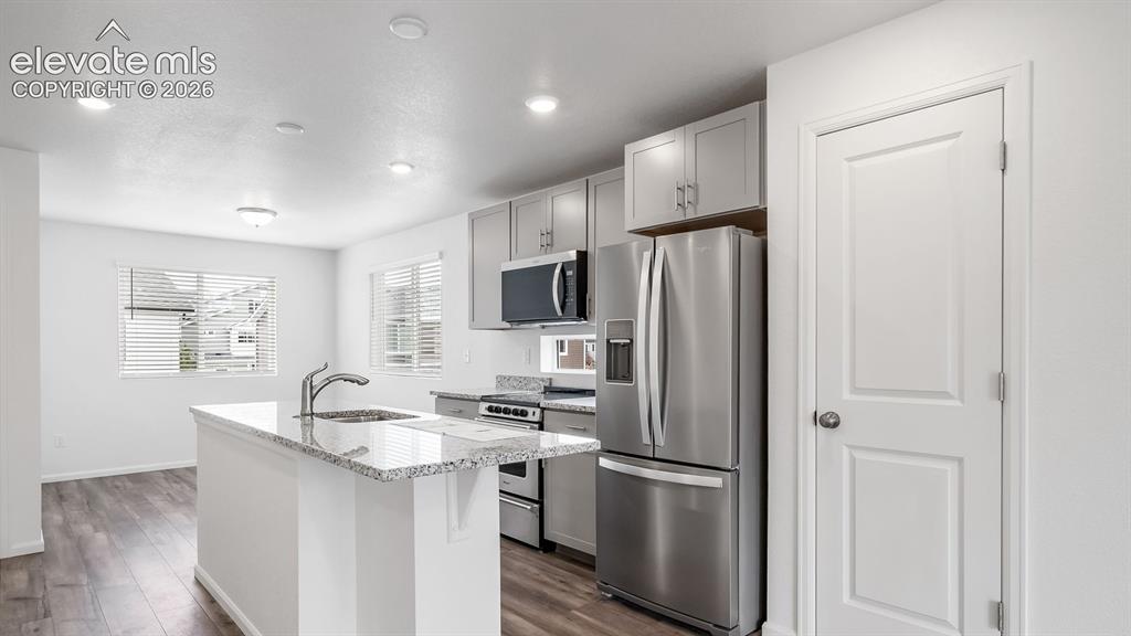 Image 22 of 36: Contemporary kitchen featuring light wood-finish flooring, recessed lightin