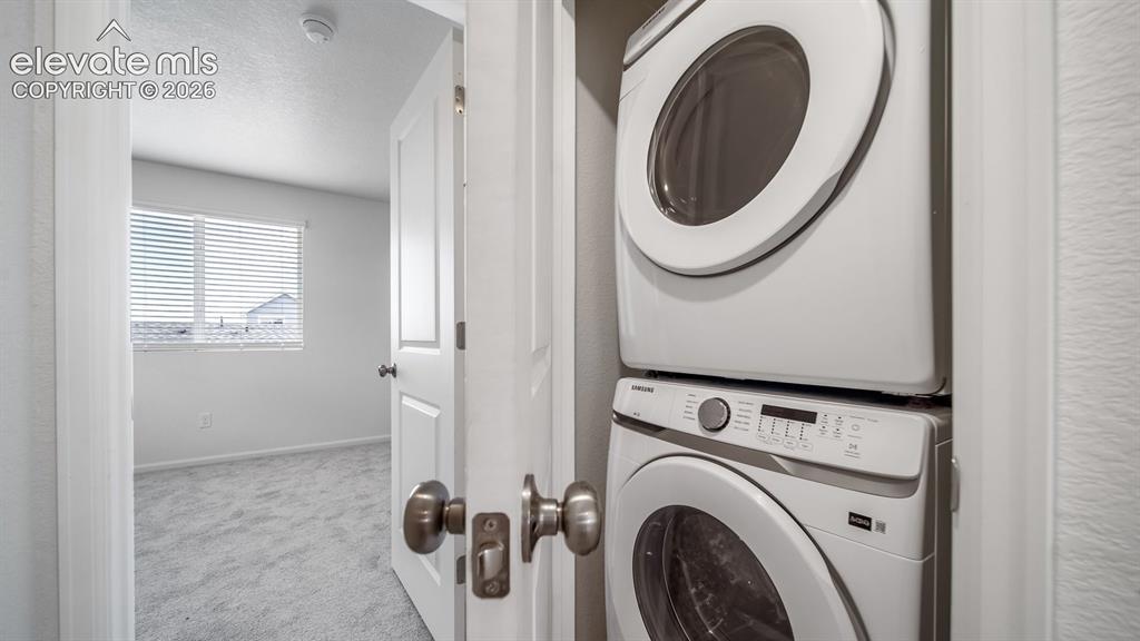 Image 24 of 36: Dedicated laundry closet featuring a stacked washer and dryer
*Photos of a