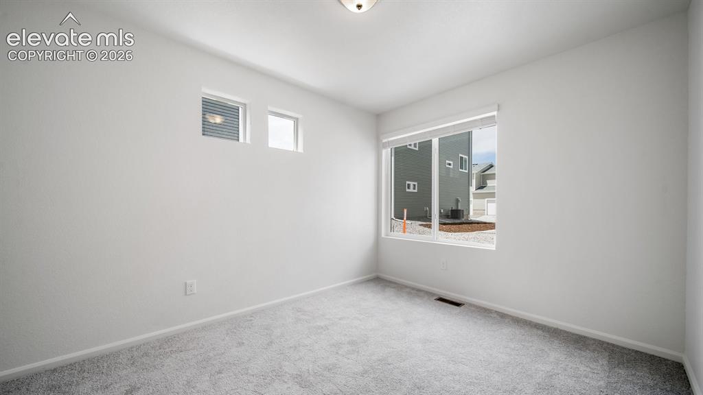 Image 30 of 36: Room featuring light gray carpeting, neutral wall finishes, and a flush-mou