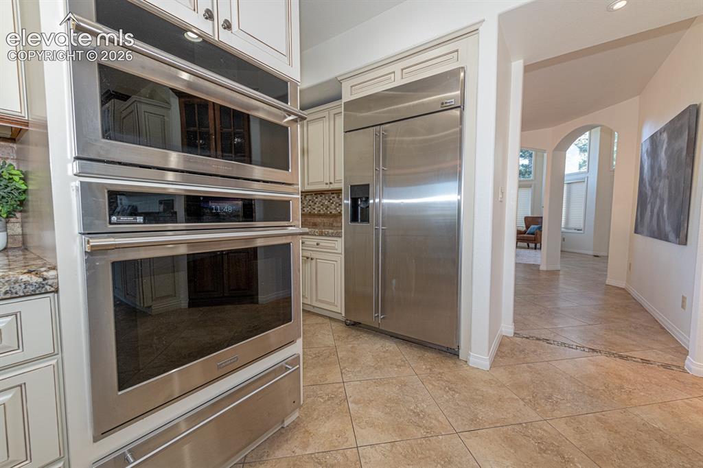 Image 12 of 50: Microwave, oven, warming drawer, oversize built in fridge
