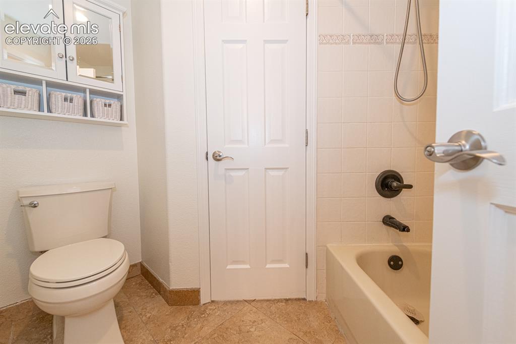 Image 31 of 50: Upstairs bed 2 and 3 Commode and tub