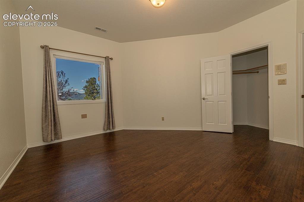 Image 41 of 50: Basement bedroom with mountain views