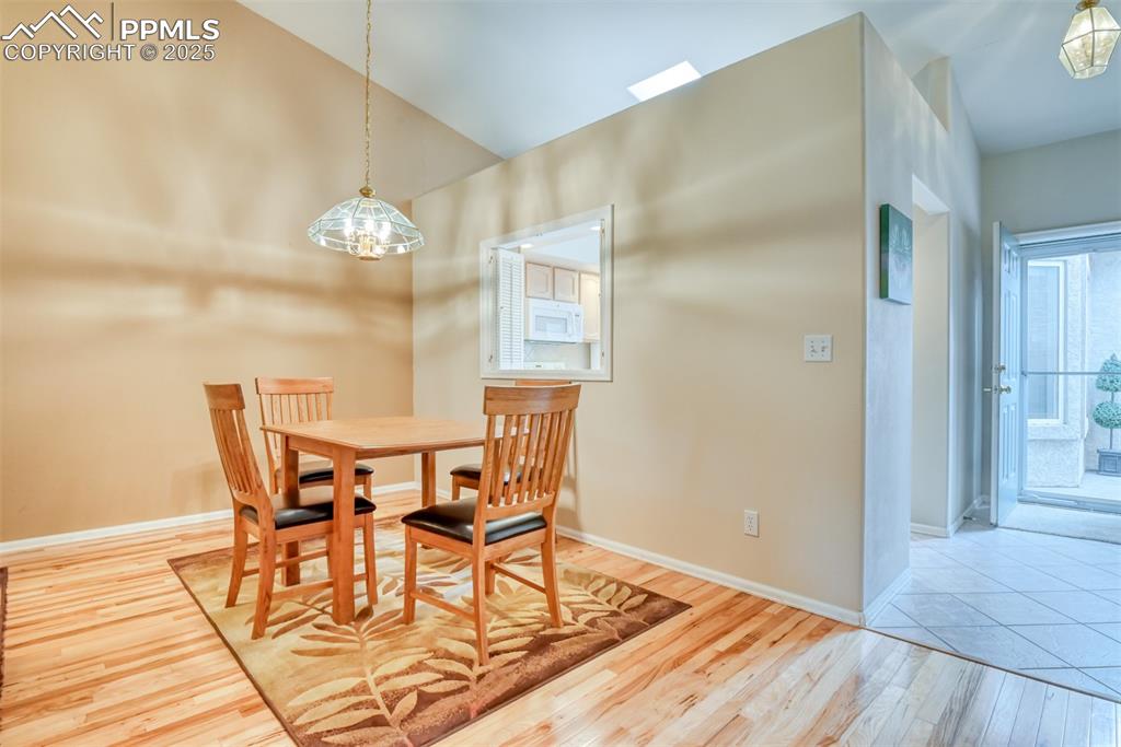 Image 15 of 37: Dining space with lofted ceiling and light wood-type flooring