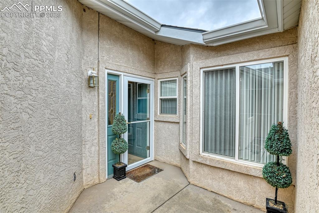 Image 2 of 37: View of exterior entry featuring stucco siding