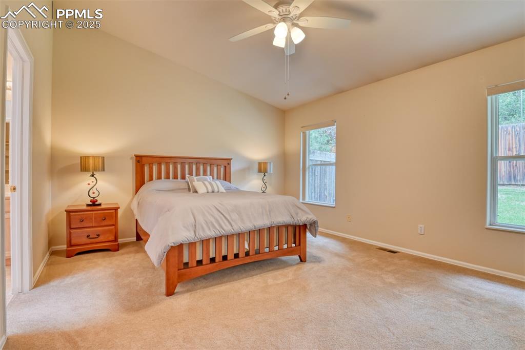 Image 22 of 37: Carpeted bedroom featuring ceiling fan and ensuite bath
