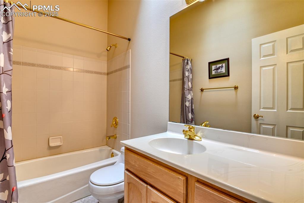Image 33 of 37: Full bathroom featuring shower / bath combination with curtain and vanity