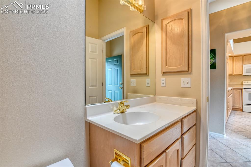 Image 34 of 37: Bathroom featuring vanity and light tile patterned flooring