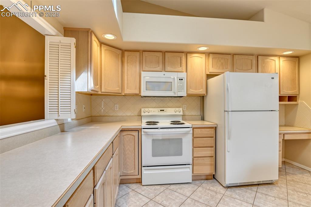 Image 4 of 37: Kitchen featuring recessed lighting, light brown cabinetry, white appliance