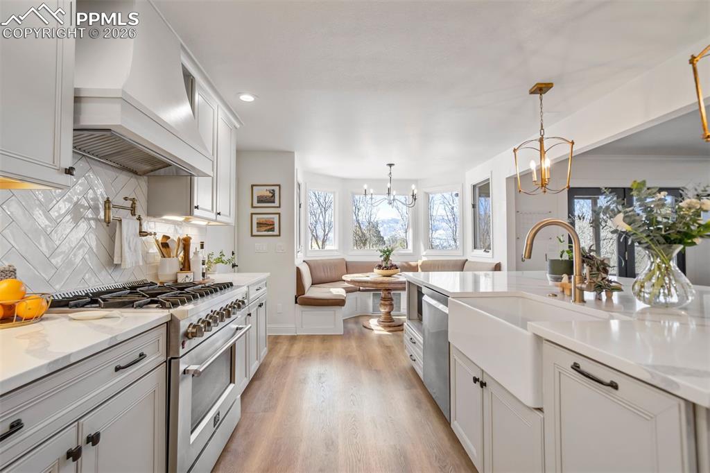 Image 14 of 49: Kitchen with stainless steel appliances, light wood-type flooring, light st