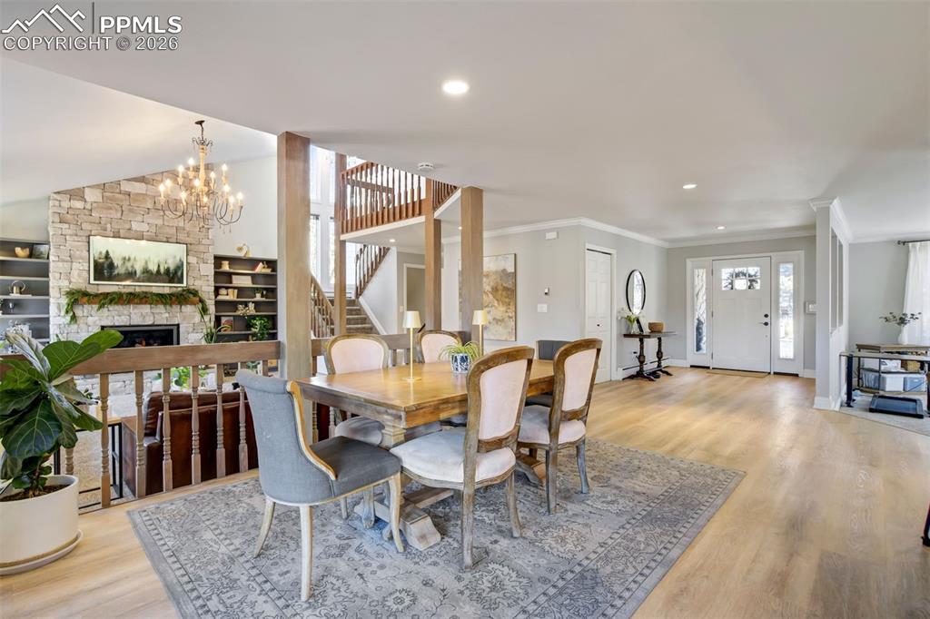 Image 18 of 49: Recently remodeledDining room with a stone fireplace, ornamental molding, l
