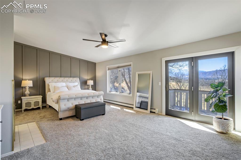 Image 26 of 49: Look at that VIEW!!!Primary bedroom with ensuite bath, fireplace, deck with