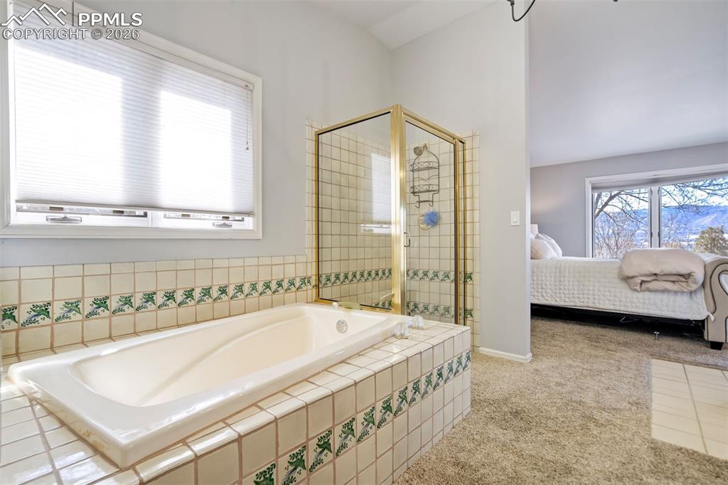 Image 29 of 49: Ensuite bathroom featuring a shower stall, and a bath and 2 walk-in closets
