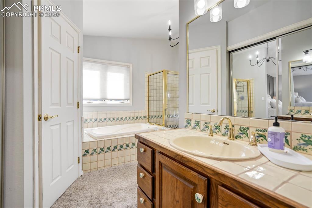 Image 30 of 49: Primary Bathroom with a garden tub, 2 separate vanities, a shower, and 2 wa