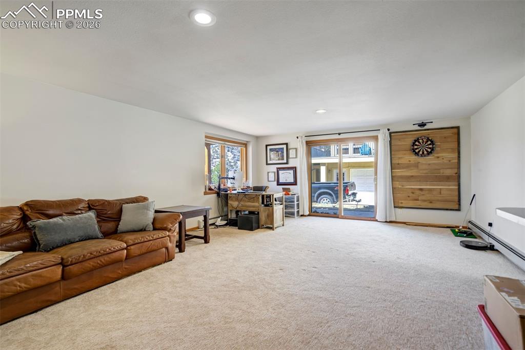 Image 39 of 49: Large family room in basement, walkout to back yard. Wet bar.