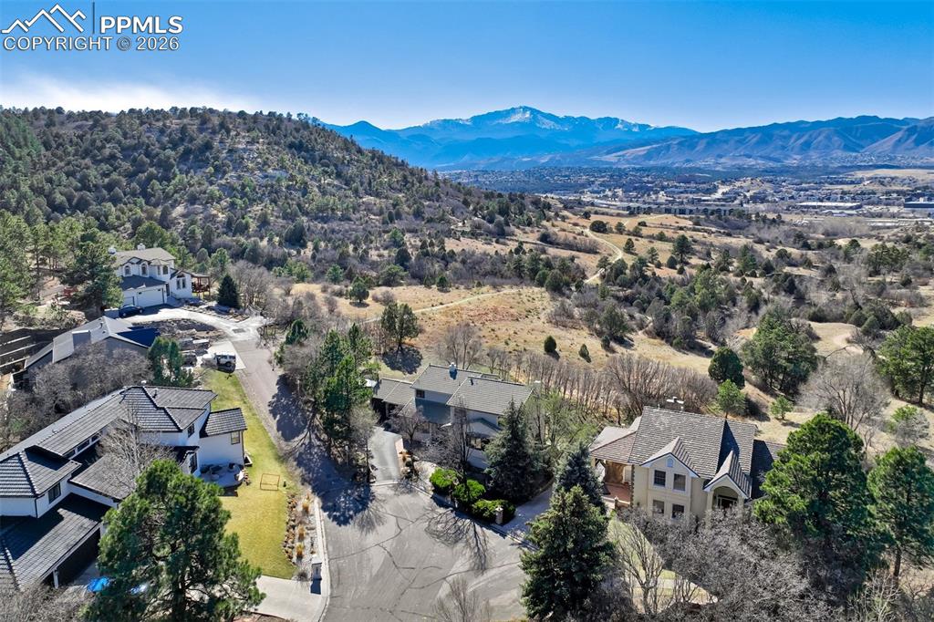 Image 4 of 49: Aerial view of residential area with a mountain backdrop