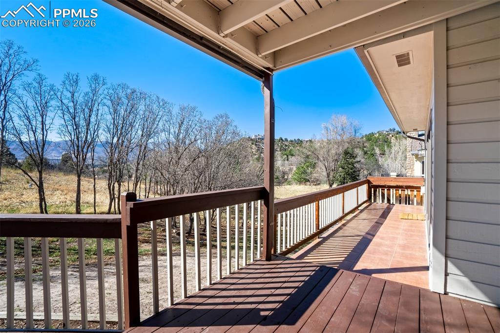 Image 44 of 49: View of deck and the amazing back yard.