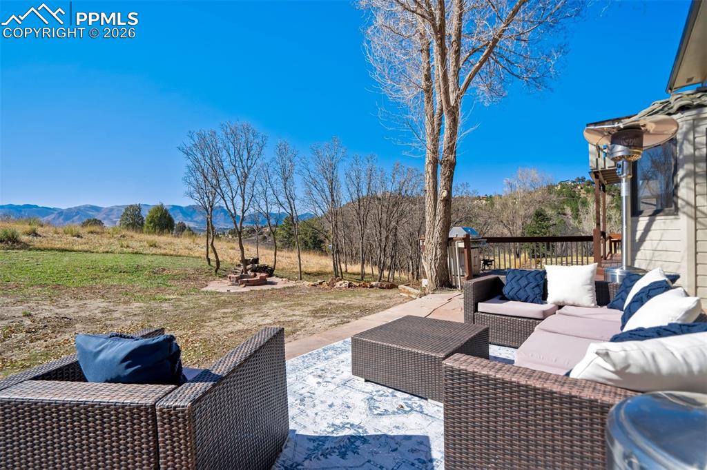 Image 45 of 49: View of flagstone patio / terrace with an outdoor hangout area and a mounta