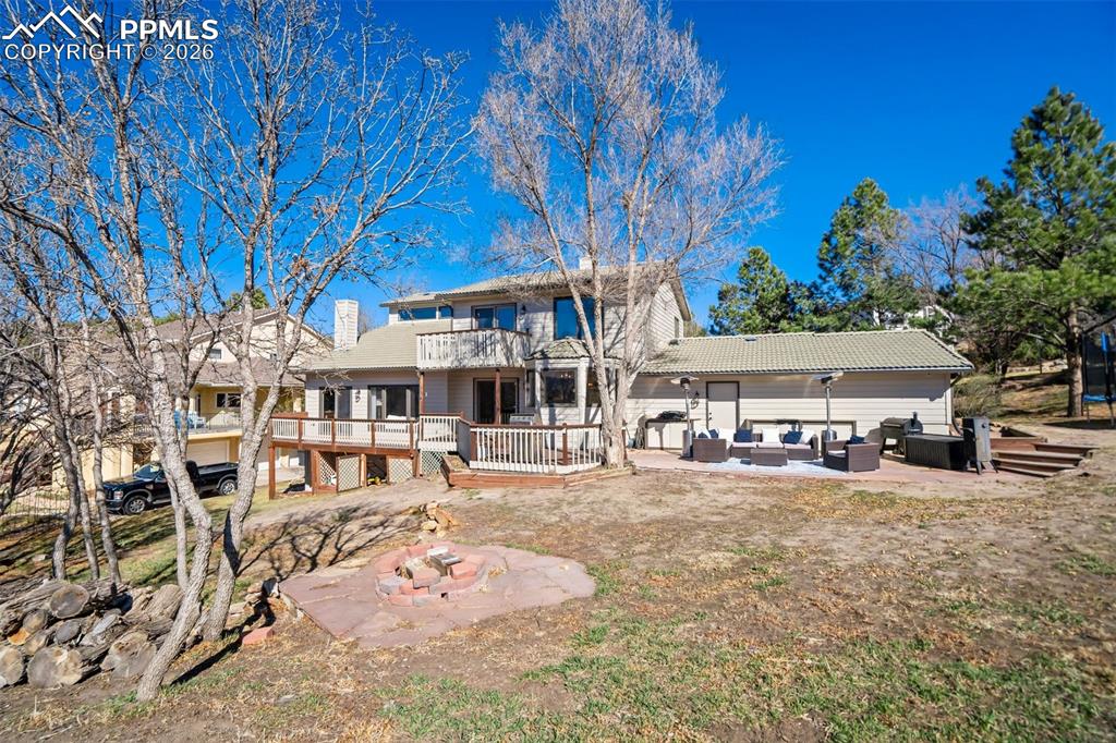 Image 46 of 49: Back of house with a patio area, outdoor seating, a trampoline, a wooden de