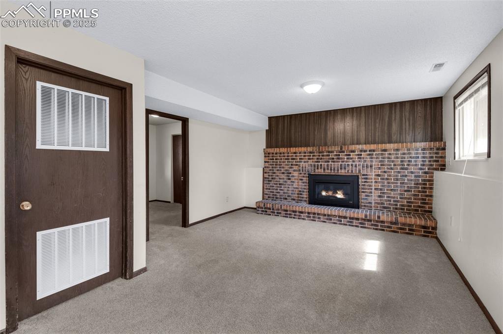 Image 13 of 49: Family room with gas fireplace and lots of natural light
