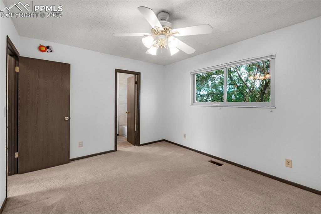 Image 15 of 49: Primary bedroom with bath adjoining