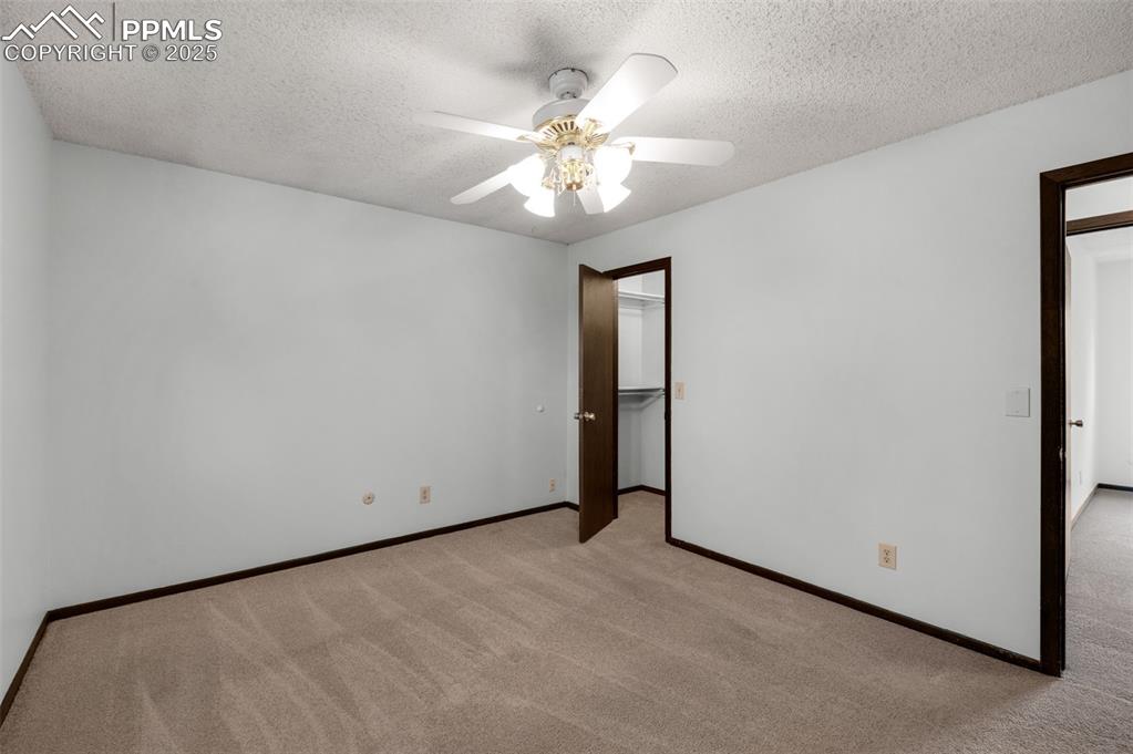 Image 16 of 49: Primary bedroom, walk-in closet and adjoining bath