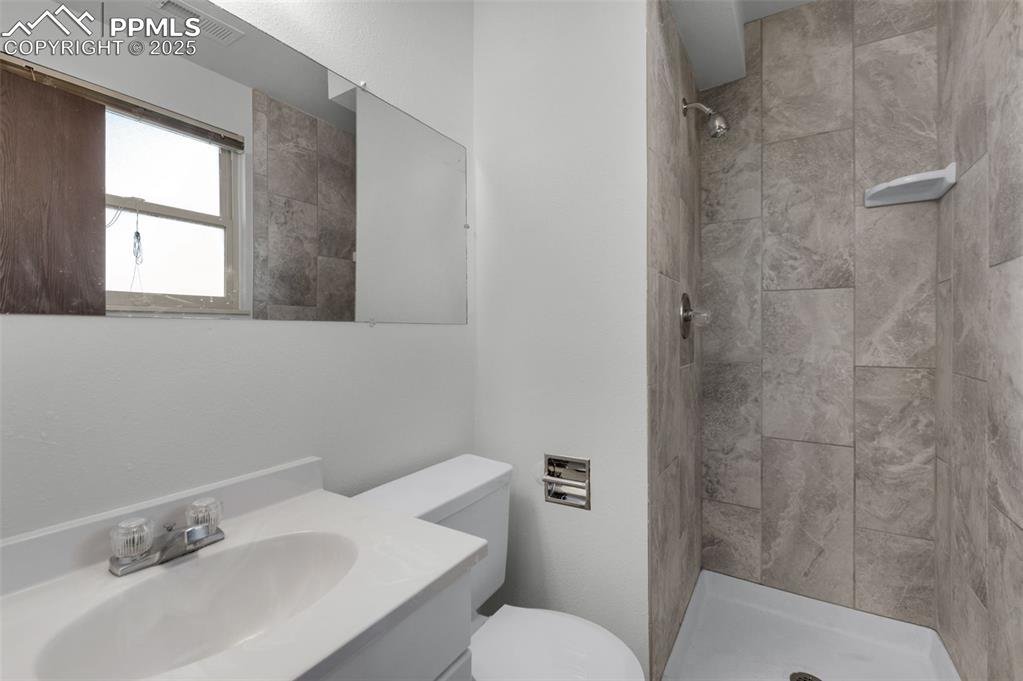 Image 25 of 49: Redone tile in lower level bath shower.