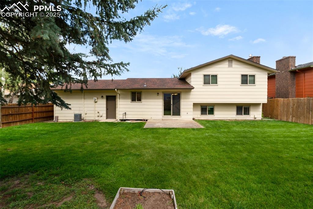 Image 35 of 49: Fenced yard and garden beds
