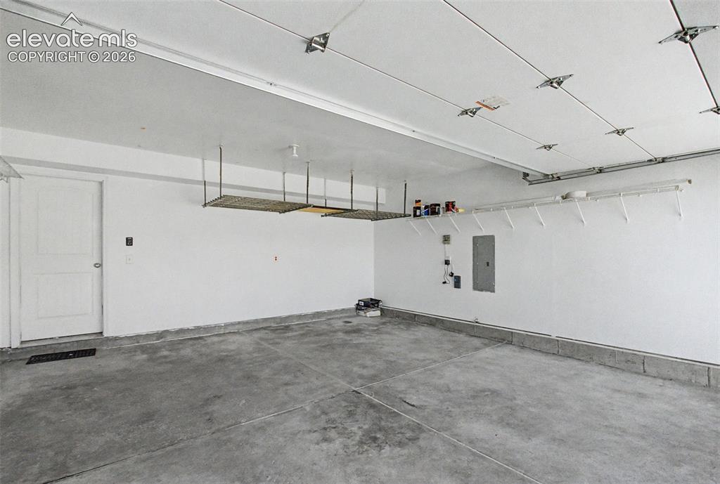 Image 38 of 42: 2 car garage w/ storage racks