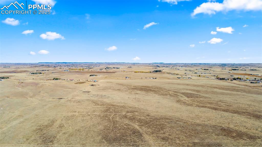 Image 11 of 19: Aerial view of sparsely populated area with a desert landscape