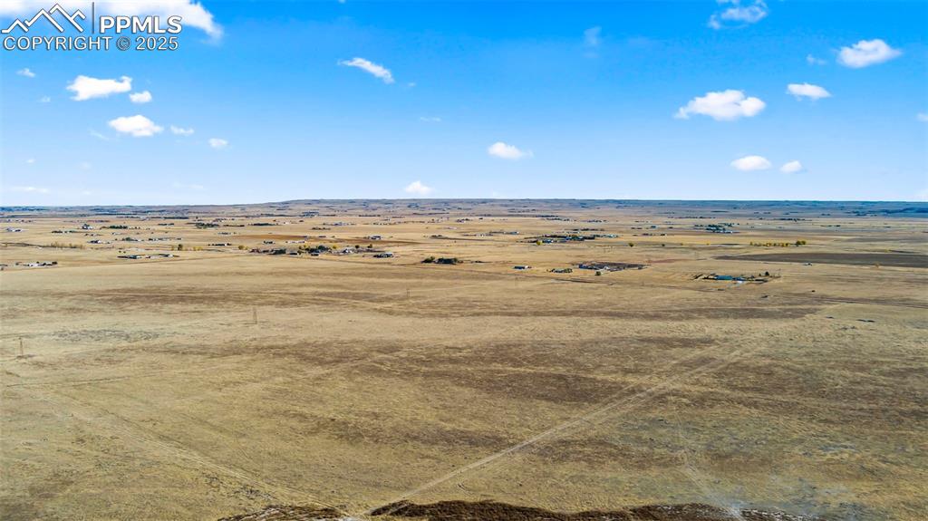 Image 12 of 19: Aerial view of sparsely populated area with a desert landscape
