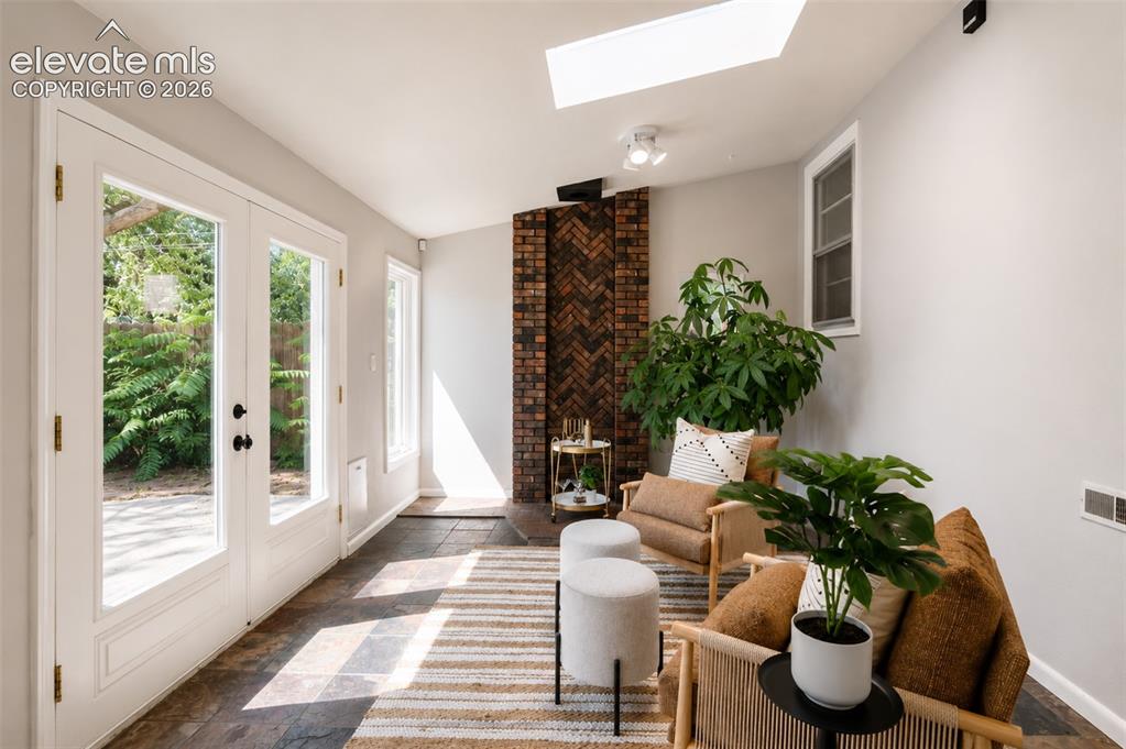 Image 27 of 50: Sun room with walkout to back yard and detached garage - main floor