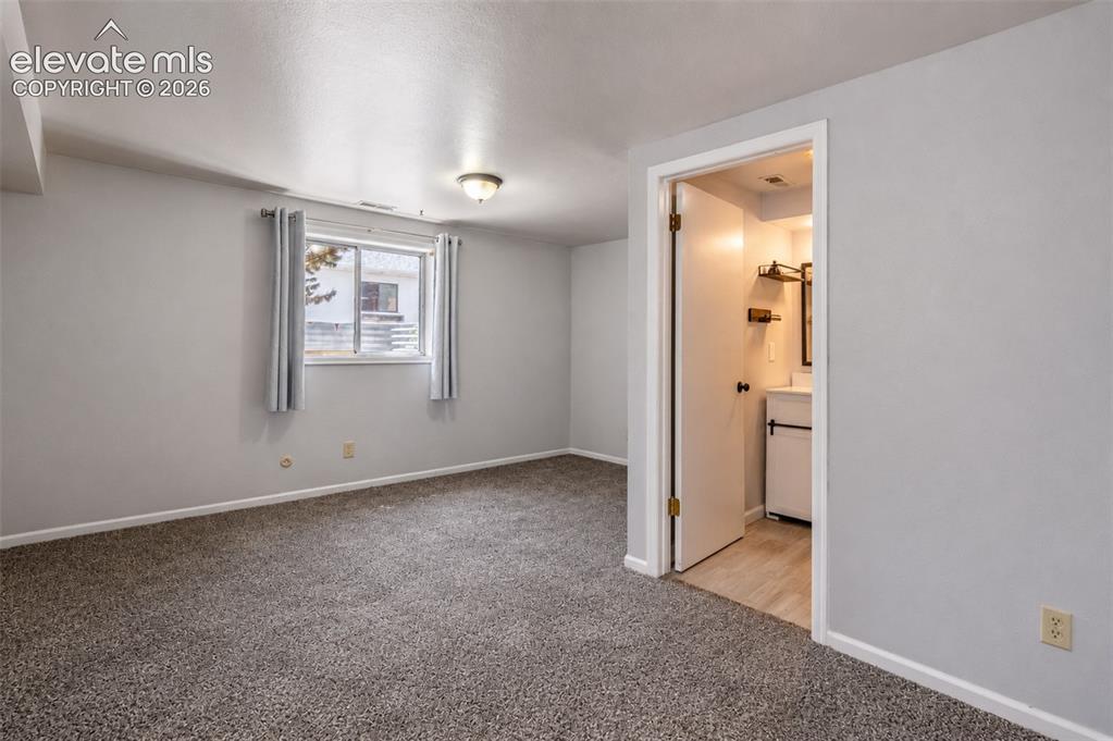 Image 38 of 50: Guest suite/downstairs primary suite/office space/future closet - basement