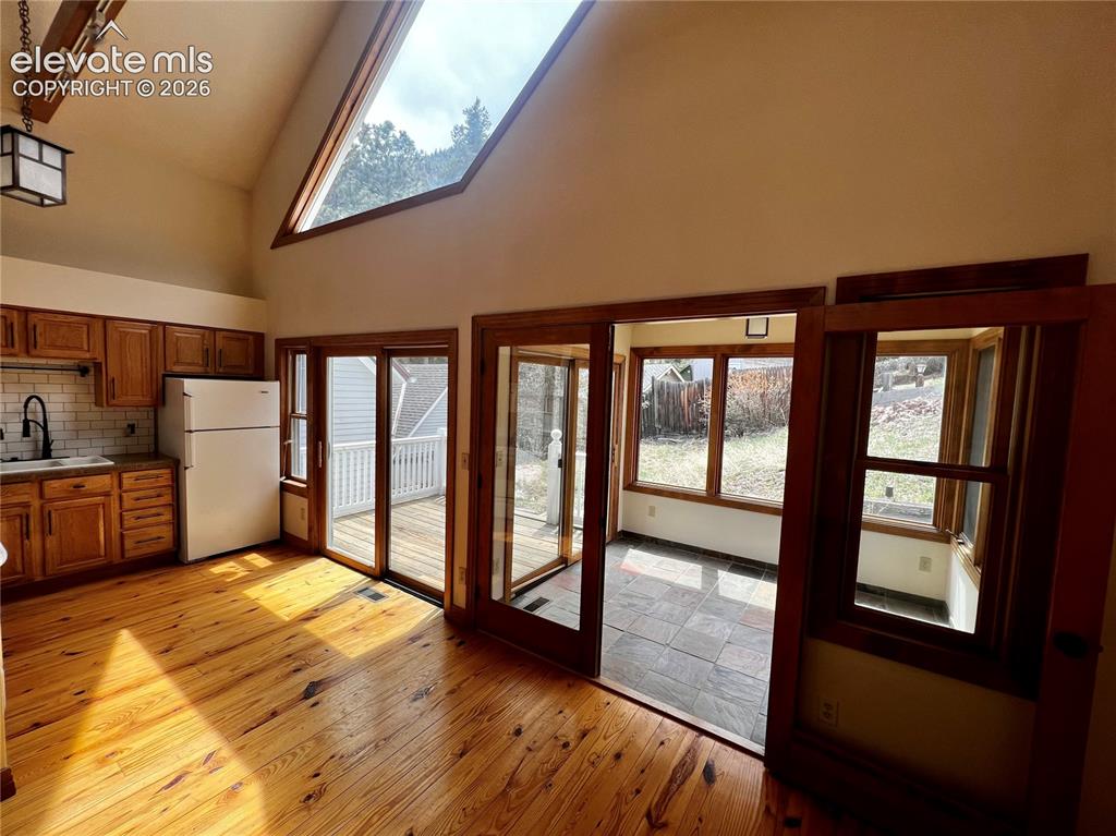 Image 13 of 45: Custom Cottage: French doors lead to the slate tiled dining room or bonus