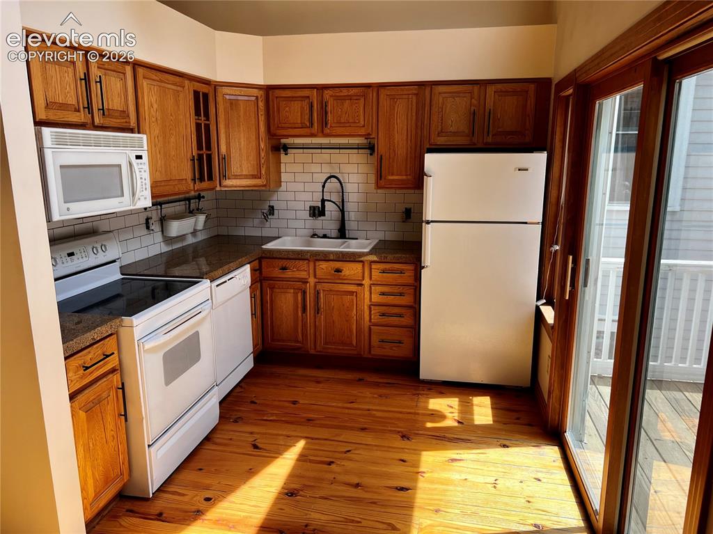 Image 14 of 45:  Custom Cottage: Kitchen includes all appliances, tiled backsplash, butcher