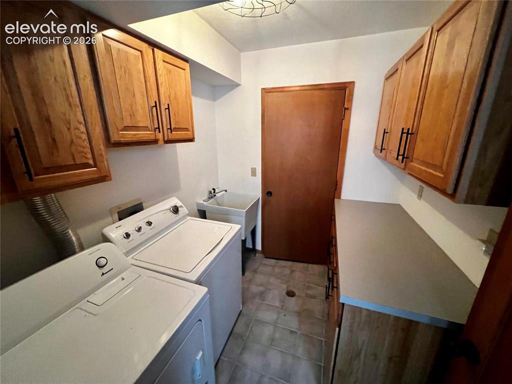 Image 21 of 45: Custom Cottage: Laundry room at the entrance with a storage room behind