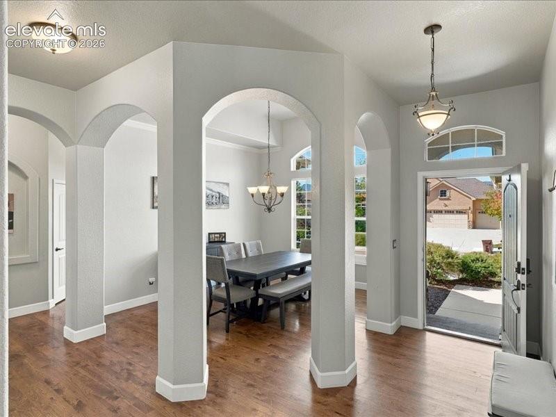 Image 23 of 50: Entryway featuring wood-finish flooring, an arched transom window, and a de