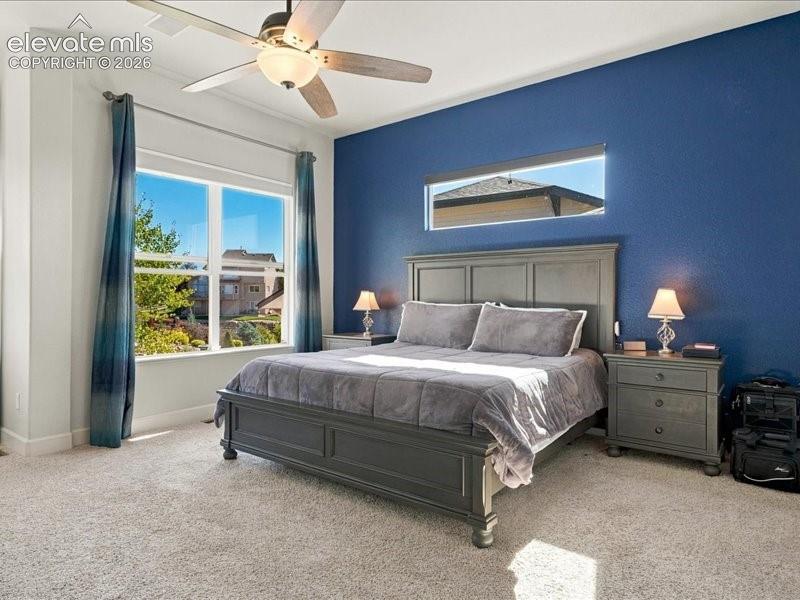 Image 25 of 50: Recessed lighting and a ceiling fan fixture complement the room