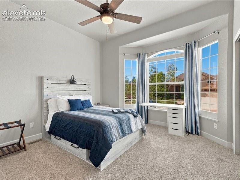 Image 30 of 50: Bay window with an arched transom, recessed lighting, ceiling fan, and carp