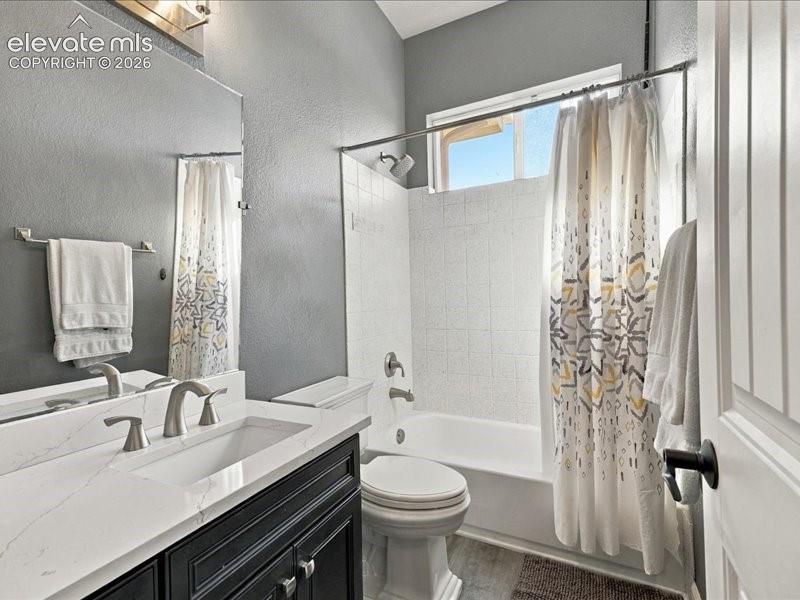 Image 32 of 50: Vanity with white integrated sink and brushed nickel fixtures, black cabine