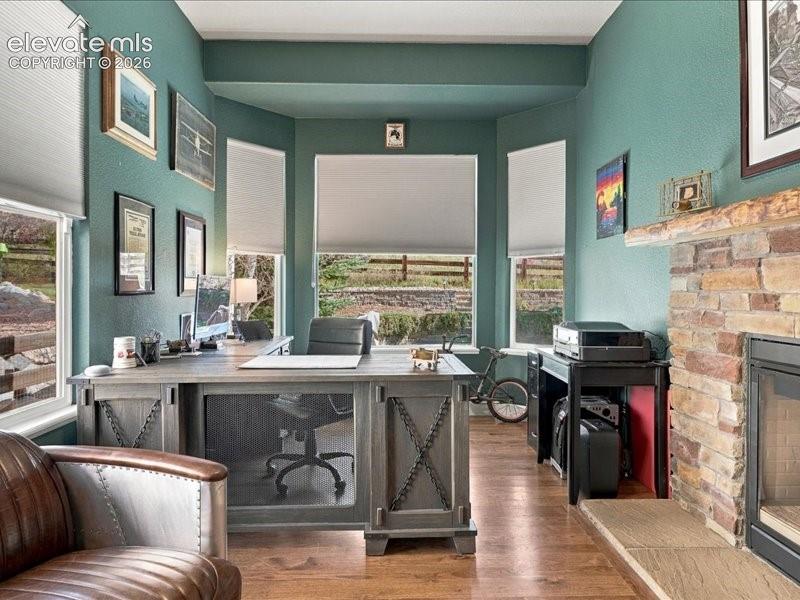 Image 35 of 50: Home office bathed in serene sage-green walls, anchored by a dual-desk work