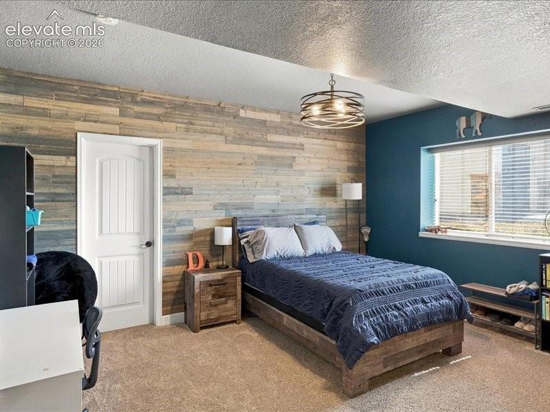 Image 47 of 50: Wood-plank accent wall, overhead drum light fixture, window with blinds, pa