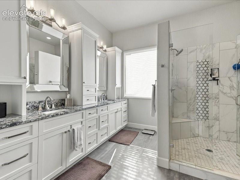 Image 7 of 50: Dual vanity with granite countertops, extensive white cabinetry, large walk
