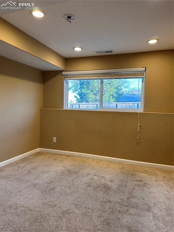 Image 5 of 23: Carpeted lower level bedroom with recessed lighting, visible vents, and bas
