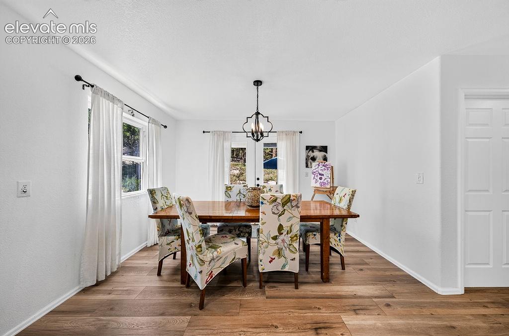 Image 23 of 50: Dining area/kitchen walks out to the yard though the double doors